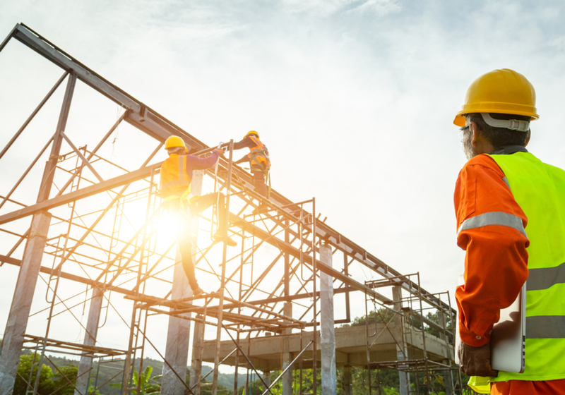 Silhouette construction industry team safely to work load concrete building according to set goal over blurred background sunset pastel for industry background.